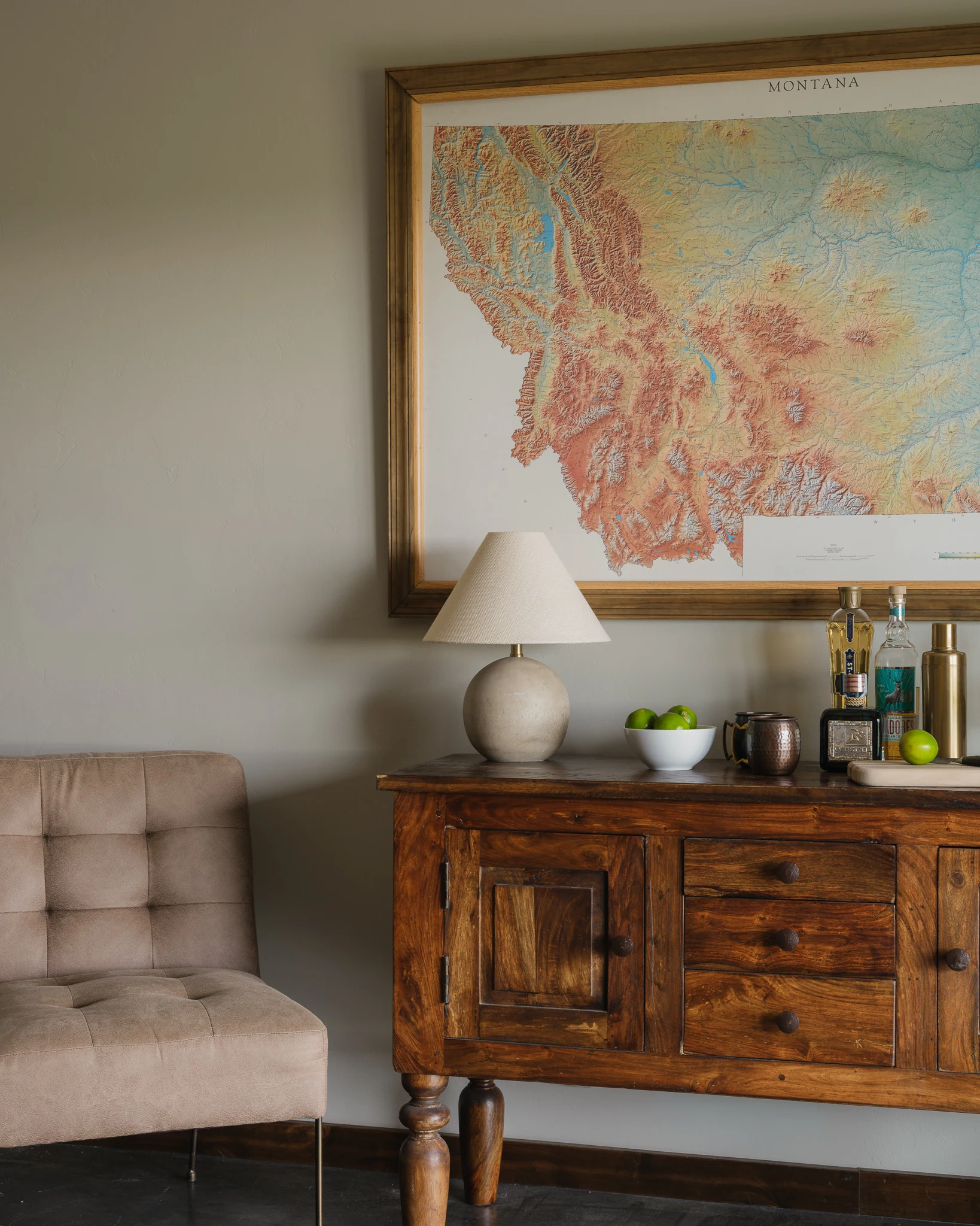 Console table styled with a vintage Montana map and bar accessories — interior design photography Livingston Montana, Bear Canyon Ranch